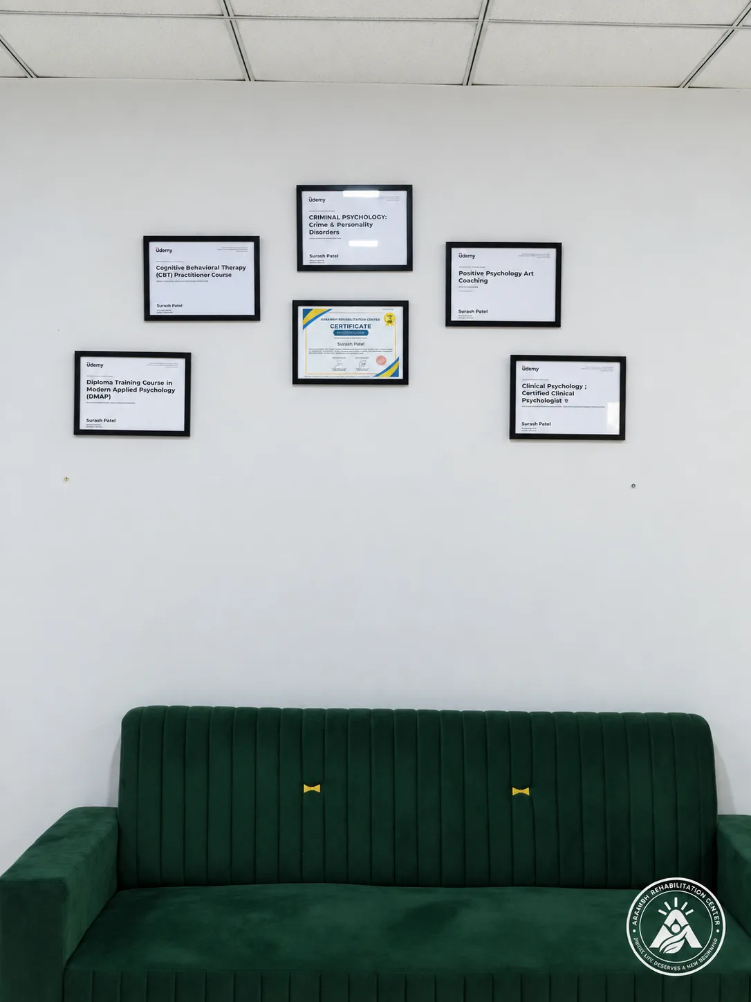 A lounge wall displaying professional certificates