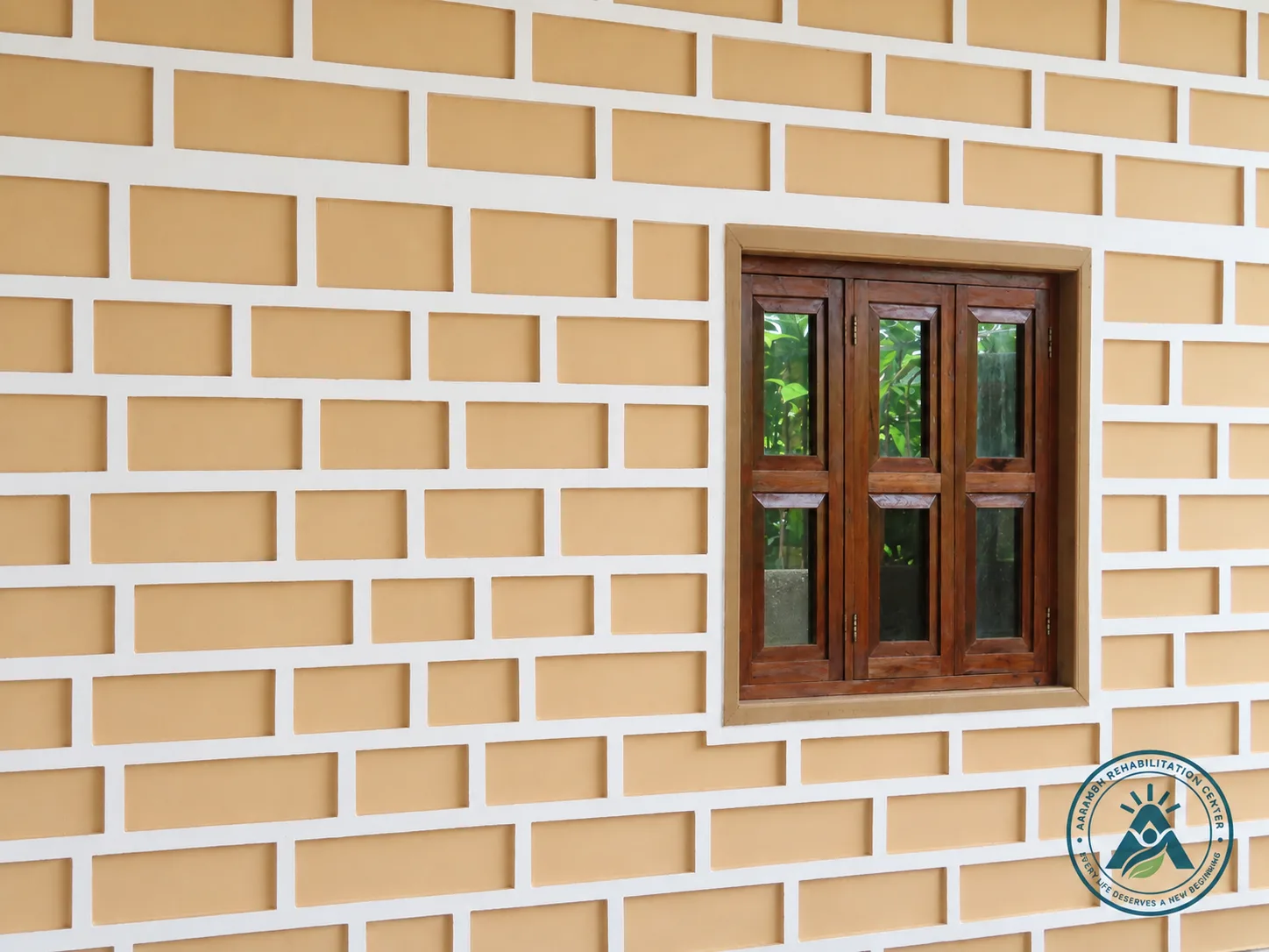 A wood-framed window on the Aarambh exterior