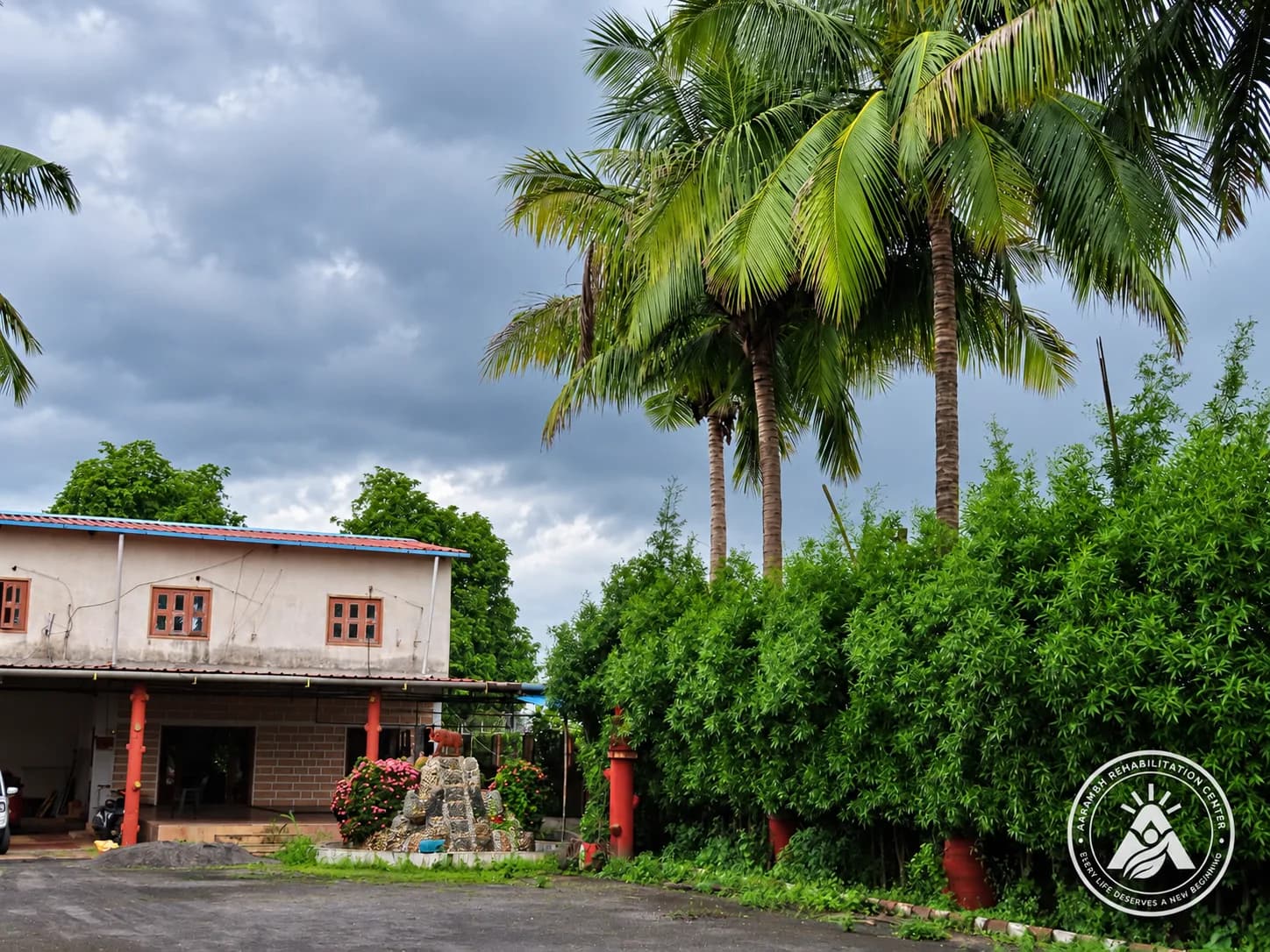 The Aarambh garden courtyard under cloudy skies