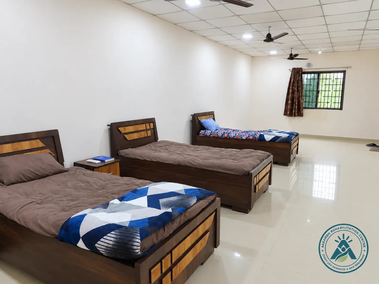A shared residential room at Aarambh